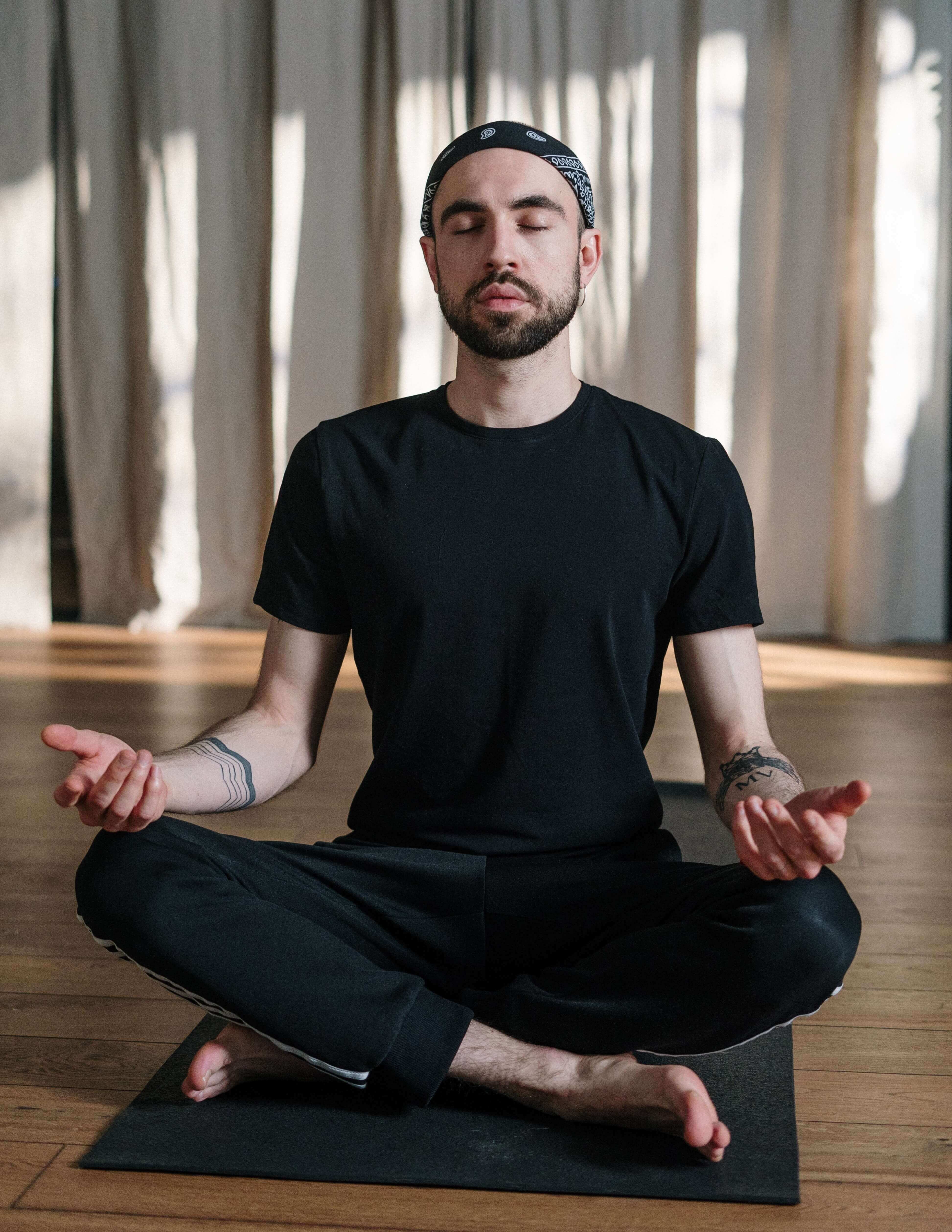 man sitting crossed legged in a peaceful meditative pose